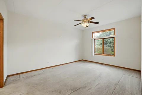 a view of room with a ceiling fan and window