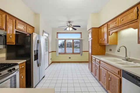 a kitchen with stainless steel appliances a sink stove and refrigerator