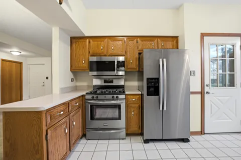 a kitchen with stainless steel appliances a refrigerator stove and sink