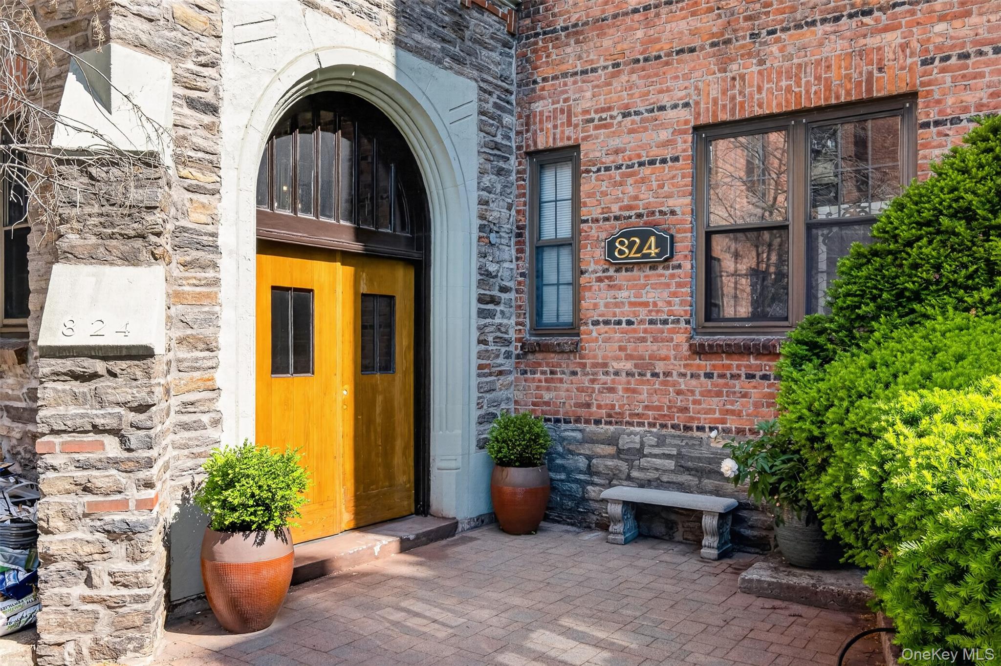 824 Bronx River Road, Unit 7C Bronxville, NY 10708 - Photo 12 of 13 a view of a brick house with potted plants