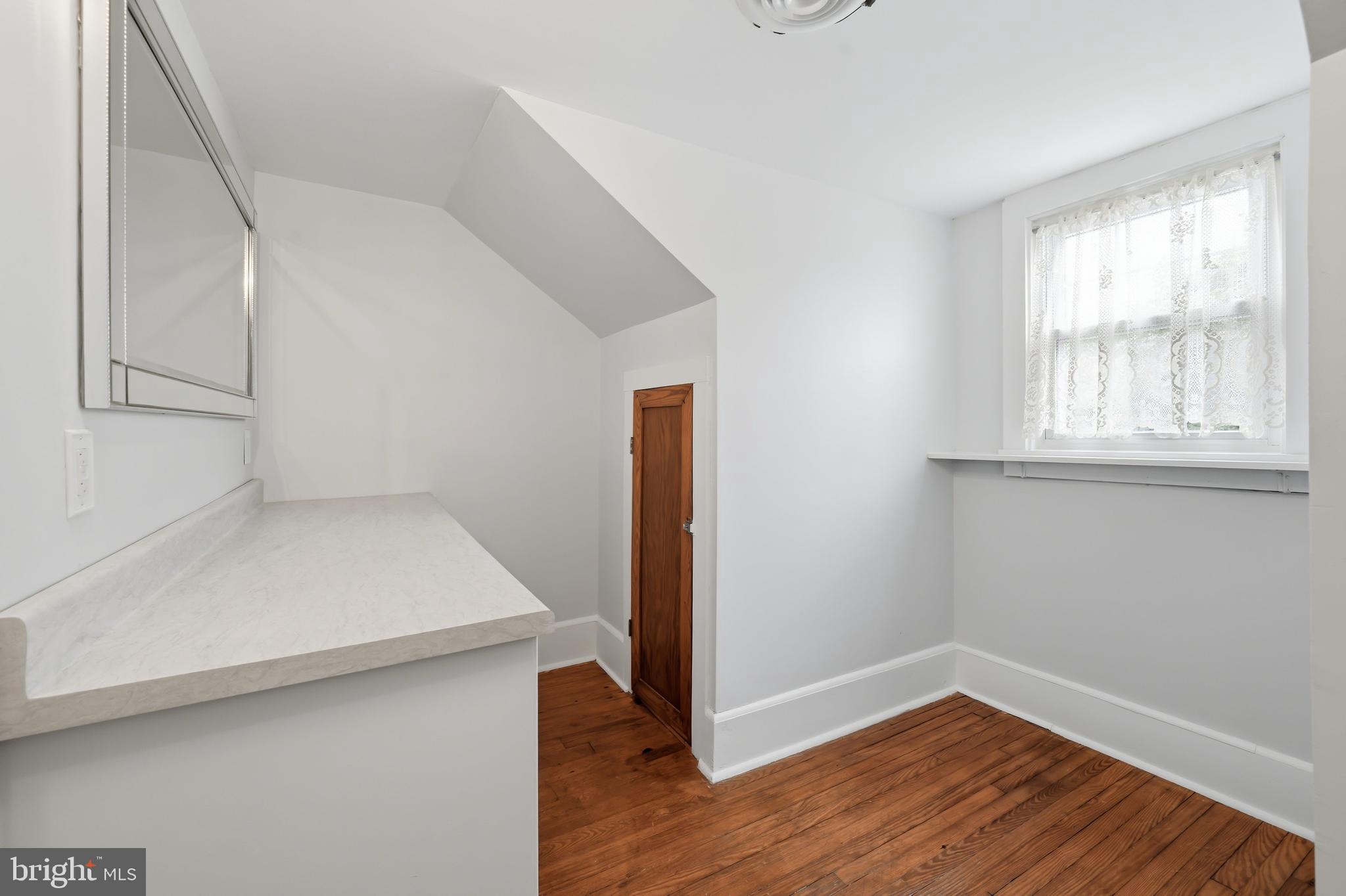 207 Crusader Road Cambridge, MD 21613 - Photo 54 of 76 a view of an empty room with wooden floor and a window