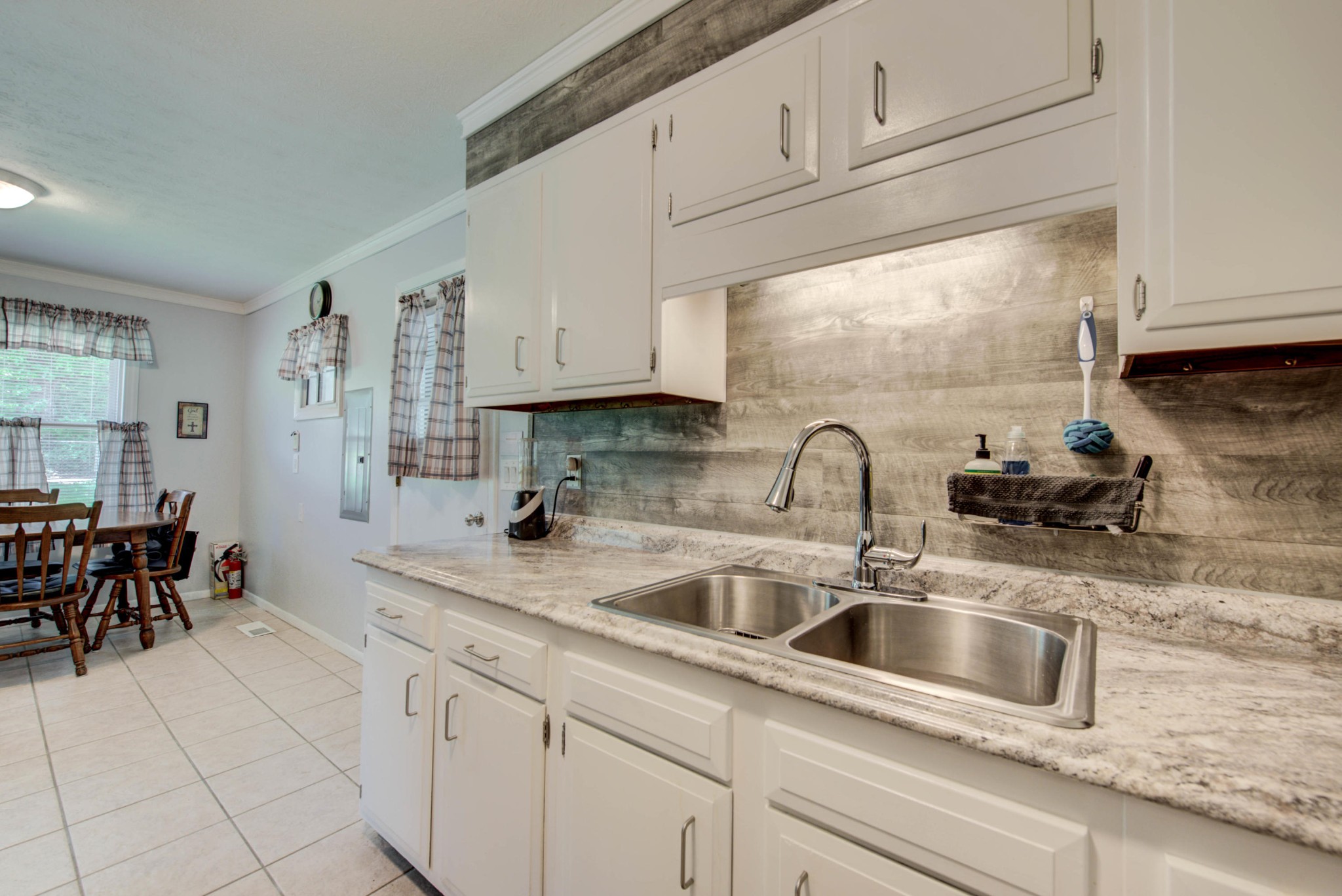 517 Foust Carney Road Powell, TN 37849 - Photo 11 of 28 a kitchen with stainless steel appliances granite countertop a sink a stove and white cabinets