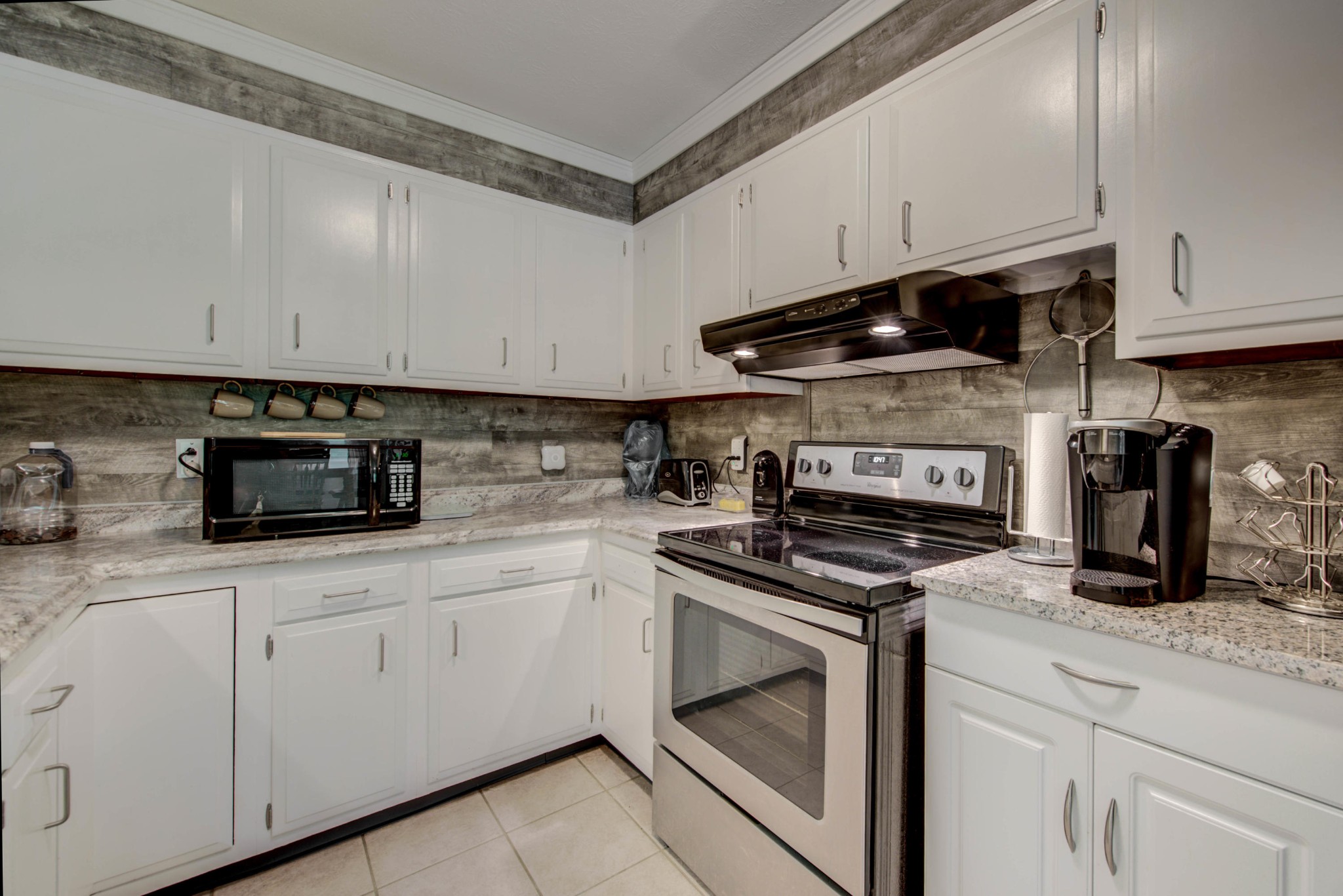 517 Foust Carney Road Powell, TN 37849 - Photo 9 of 28 a kitchen with white cabinets and appliances