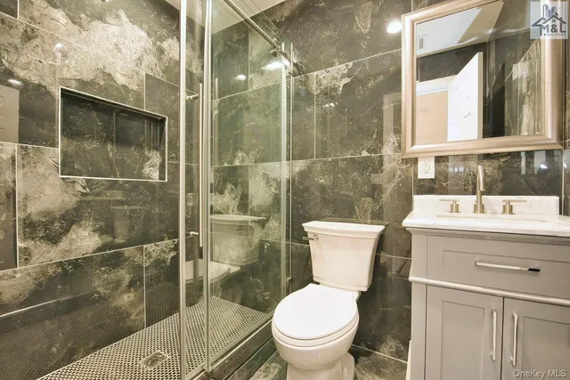a bathroom with a sink toilet and shower