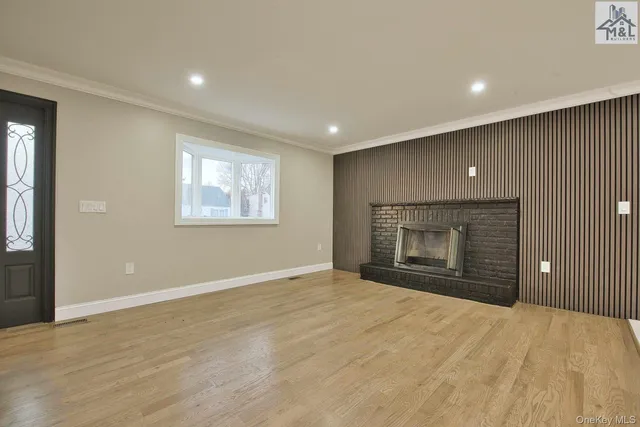 an empty room with a fireplace and window