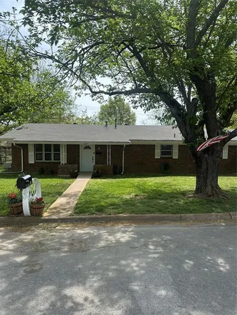 a front view of house with a garden and porch