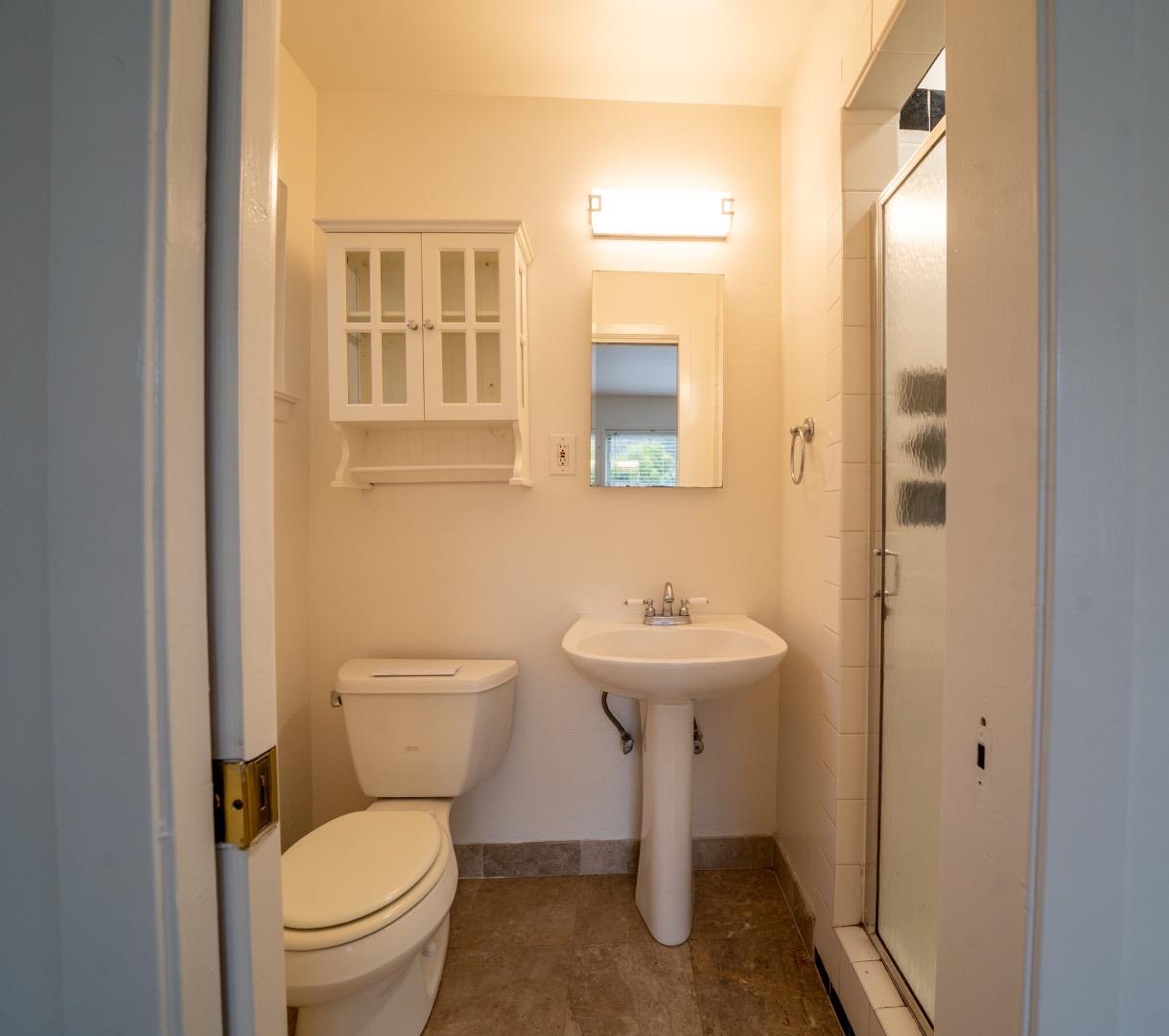 616 Brighton Road Pacifica, CA 94044 - Photo 11 of 14 a bathroom with a sink toilet and mirror