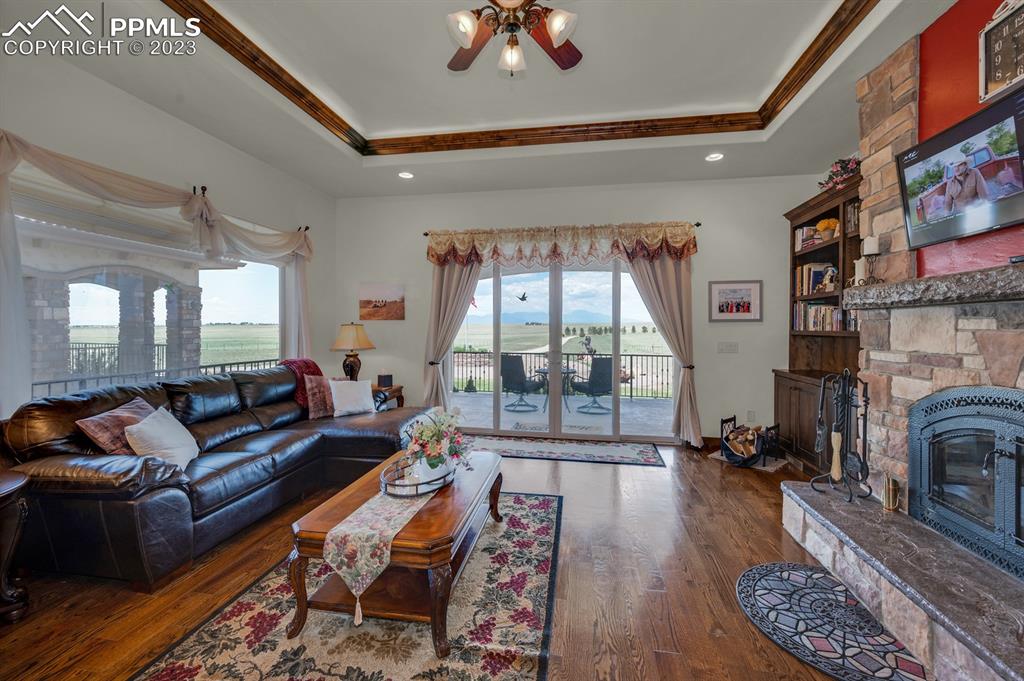 19625 Drennan Road Colorado Springs, CO 80928 - Photo 15 of 50 a living room with fireplace furniture and a floor to ceiling window
