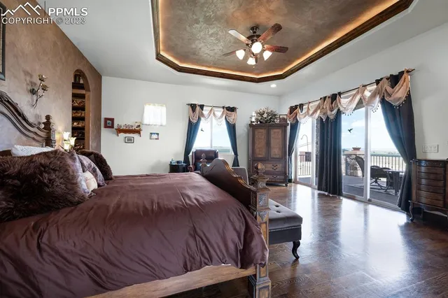 a bedroom with a bed and a chandelier