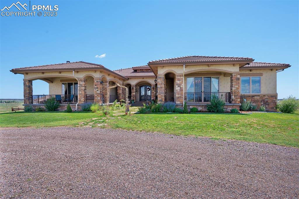 19625 Drennan Road Colorado Springs, CO 80928 - Photo 2 of 50 a front view of house with yard and green space