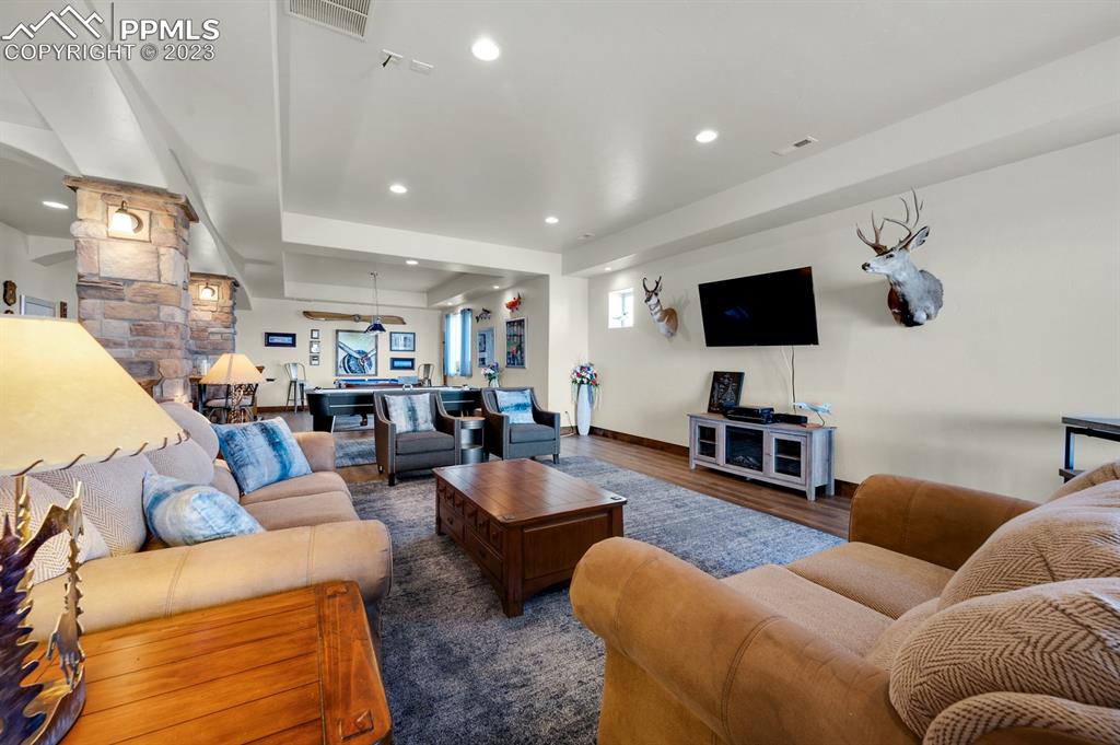 19625 Drennan Road Colorado Springs, CO 80928 - Photo 28 of 50 a living room with furniture and a flat screen tv