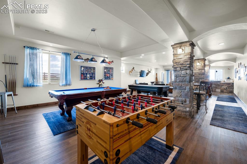19625 Drennan Road Colorado Springs, CO 80928 - Photo 29 of 50 a living room with furniture a table and wooden floor