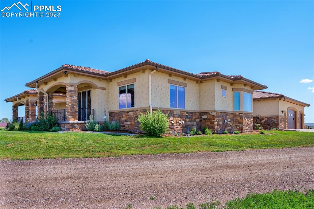 19625 Drennan Road Colorado Springs, CO 80928 - Photo 3 of 50 a front view of a house with a yard