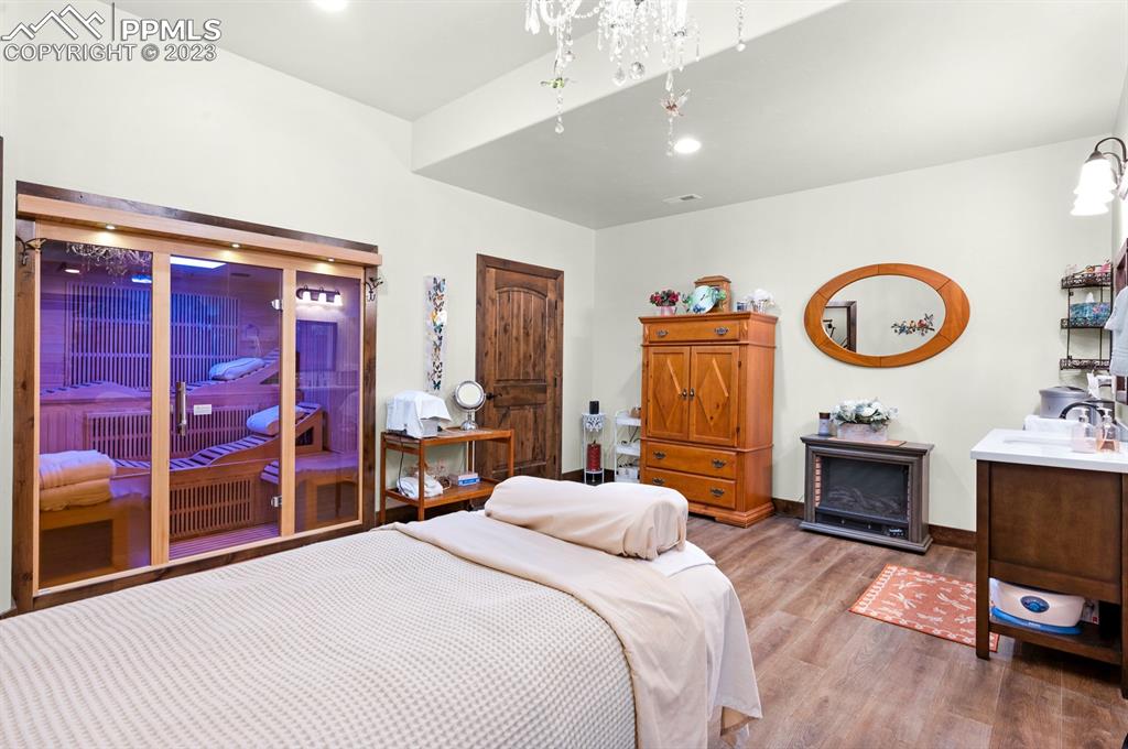 19625 Drennan Road Colorado Springs, CO 80928 - Photo 33 of 50 a bedroom with a bed and a chandelier