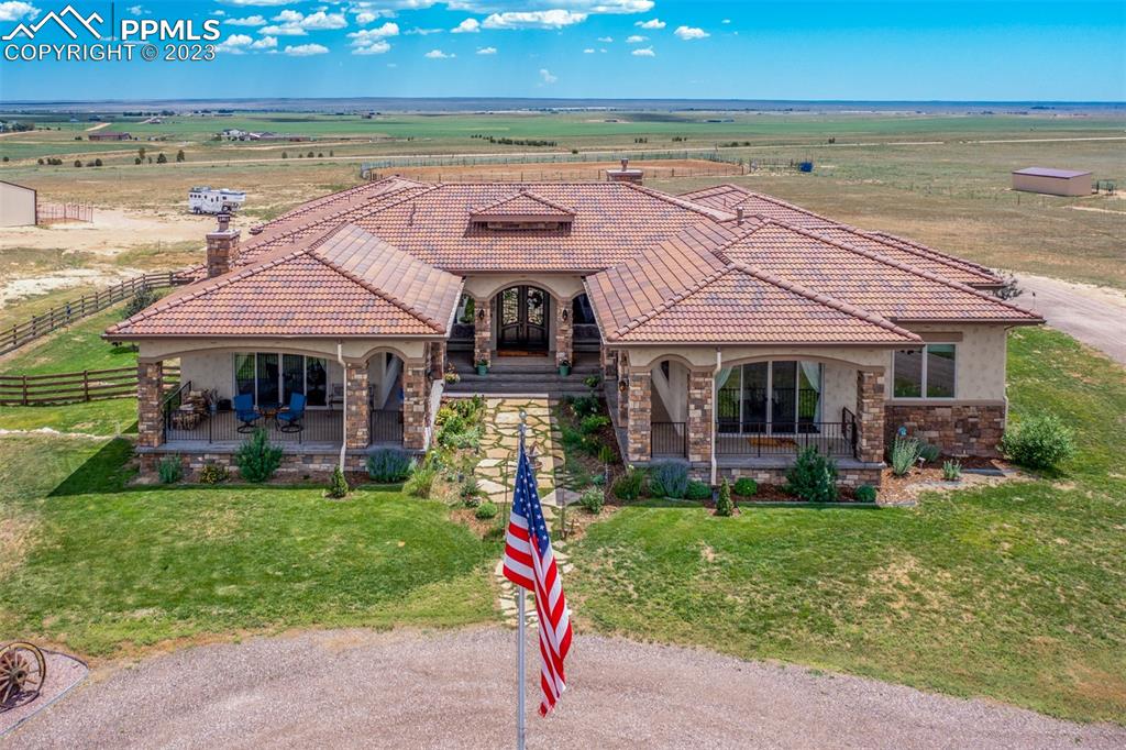 19625 Drennan Road Colorado Springs, CO 80928 - Photo 4 of 50 a front view of a house with a yard table and chairs
