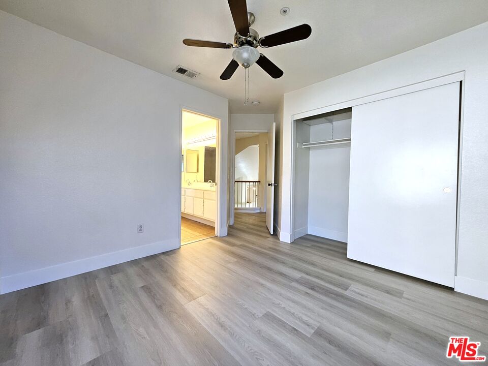 7254 Brienza Place Rancho Cucamonga, CA 91701 - Photo 12 of 17 a view of an empty room with wooden floor and a window