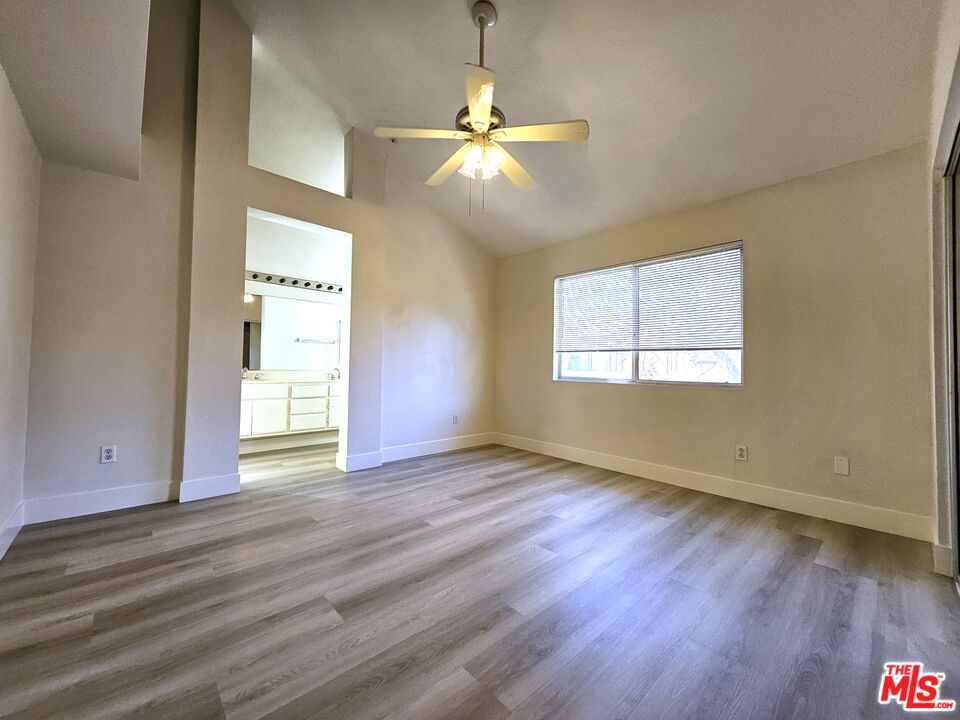 7254 Brienza Place Rancho Cucamonga, CA 91701 - Photo 13 of 17 a view of an empty room with wooden floor and a window