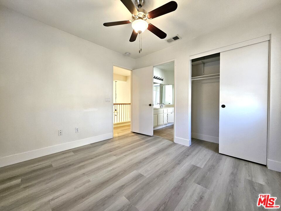 7254 Brienza Place Rancho Cucamonga, CA 91701 - Photo 8 of 17 a view of empty room with wooden floor and fan