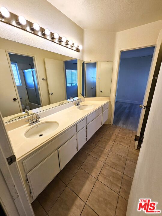 7254 Brienza Place Rancho Cucamonga, CA 91701 - Photo 10 of 17 a spacious bathroom with a double vanity sink and a mirror