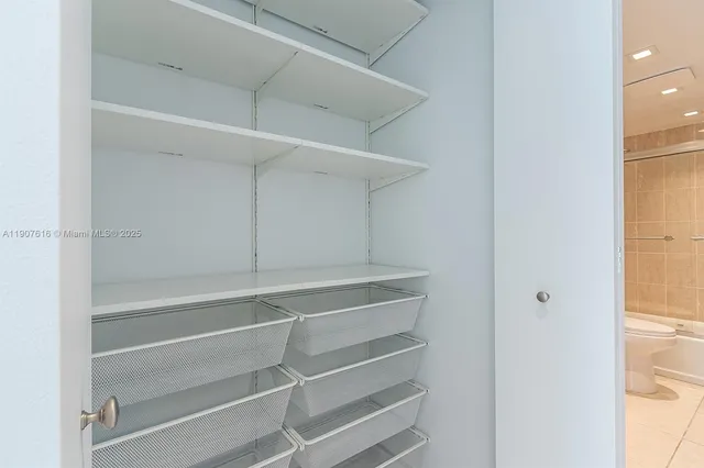 a view of walk in closet with empty racks