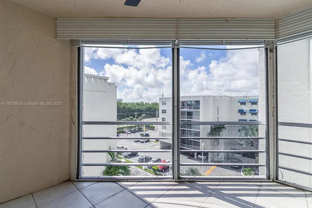 a room with stainless steel appliances wooden floor and a large window