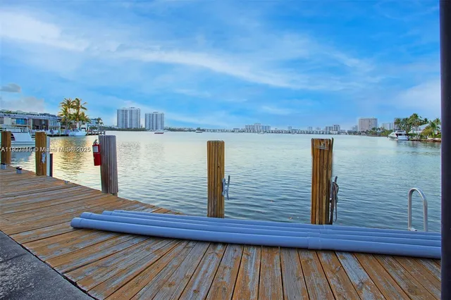 a view of a balcony with wooden floor and lake view