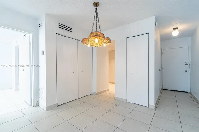 a room that has a mirror and a chandelier in it