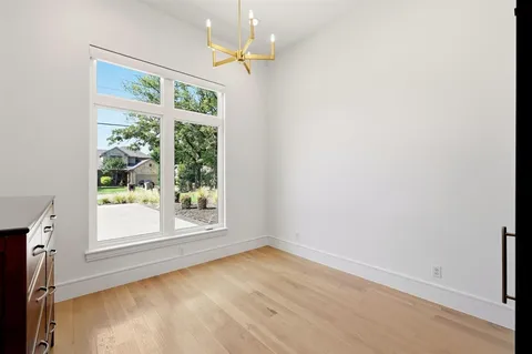 an empty room with windows and outdoor view