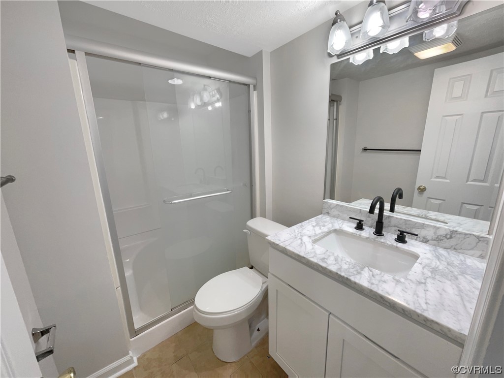 9407 Emmett Road Glen Allen, VA 23060 - Photo 13 of 18 a bathroom with a granite countertop sink a toilet and a mirror