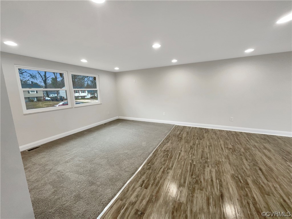 9407 Emmett Road Glen Allen, VA 23060 - Photo 7 of 18 an empty room with wooden floor and windows