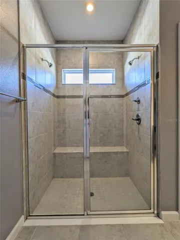 a bathroom with a glass shower door
