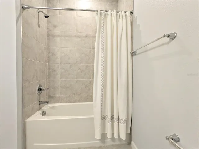 a bathroom with a shower and a bathtub
