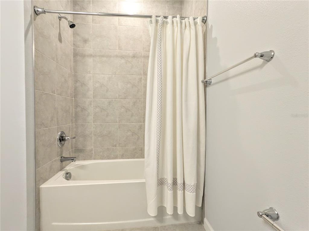 6205 114th Avenue East Parrish, FL 34219 - Photo 21 of 33 a bathroom with a shower and a bathtub