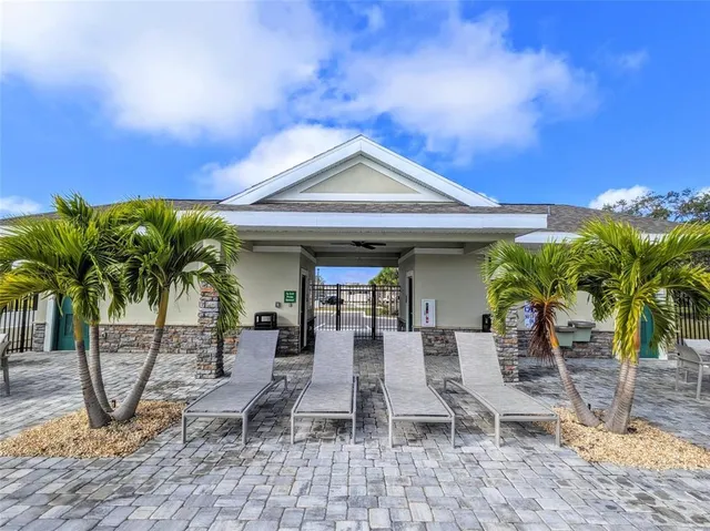 a view of a house with backyard and sitting area