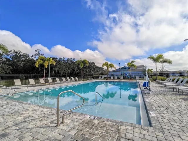 a view of a swimming pool with a lounge chair