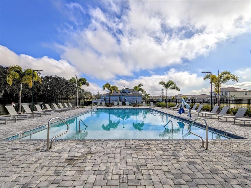 6205 114th Avenue East Parrish, FL 34219 - Photo 28 of 33 a view of a swimming pool with a lounge chairs