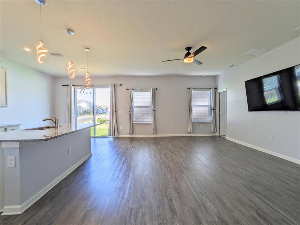 6205 114th Avenue East Parrish, FL 34219 - Photo 3 of 33 a view of an empty room with window and wooden floor