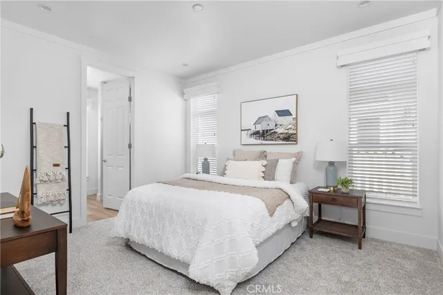 a bedroom with a bed table and a window
