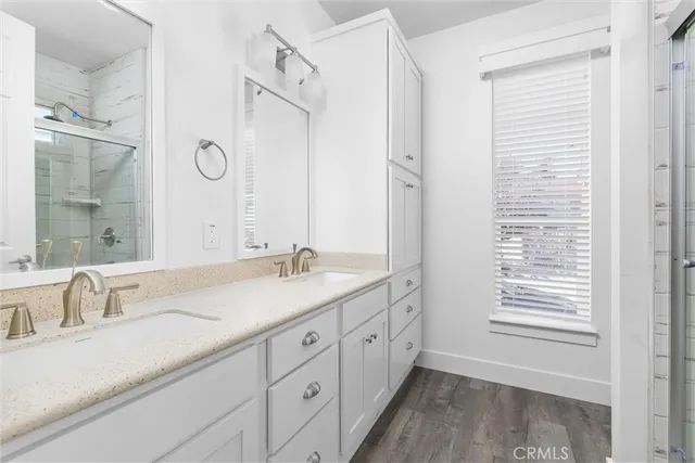 a bathroom with double vanity sink and a mirror