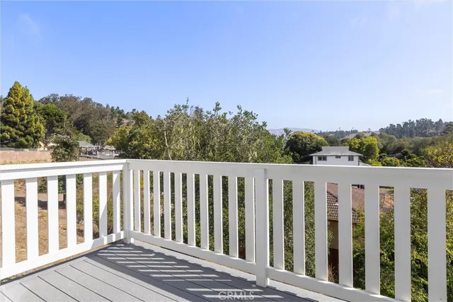 a balcony with wooden floor and fence