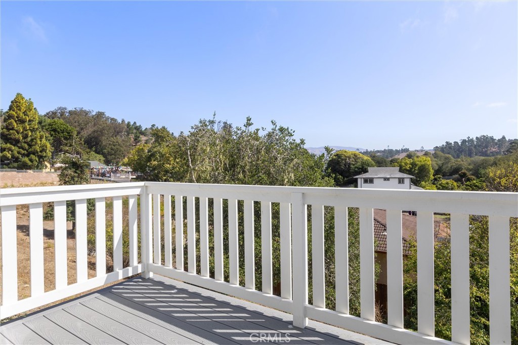 1460 Main Street, Unit 117 Cambria, CA 93428 - Photo 7 of 23 a balcony with wooden floor and fence