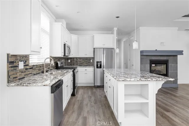 a kitchen with a sink stove and refrigerator