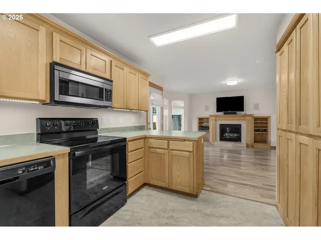 a kitchen with stainless steel appliances granite countertop a stove microwave and a sink