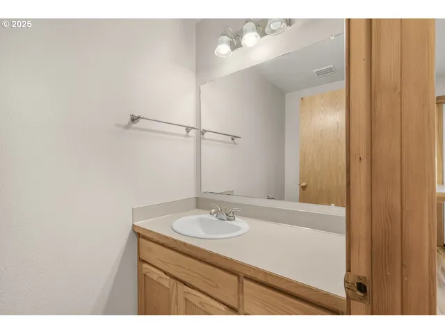 a view of a backyard with table and chairs under an umbrella