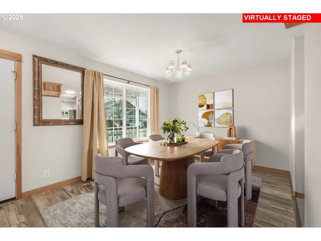 a view of a dining room with furniture and chandelier