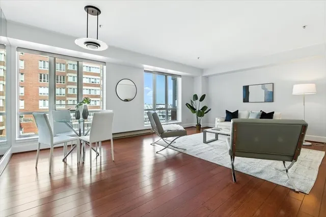a living room with furniture a table and wooden floor