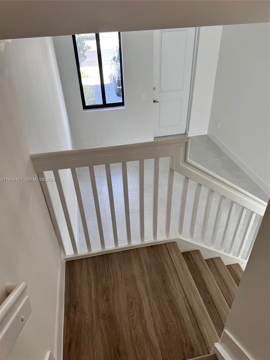 18945 Southwest 344th Terrace Homestead, FL 33034 - Photo 3 of 12 a view of staircase with railing and a rug