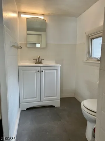 a bathroom with a sink a toilet and mirror