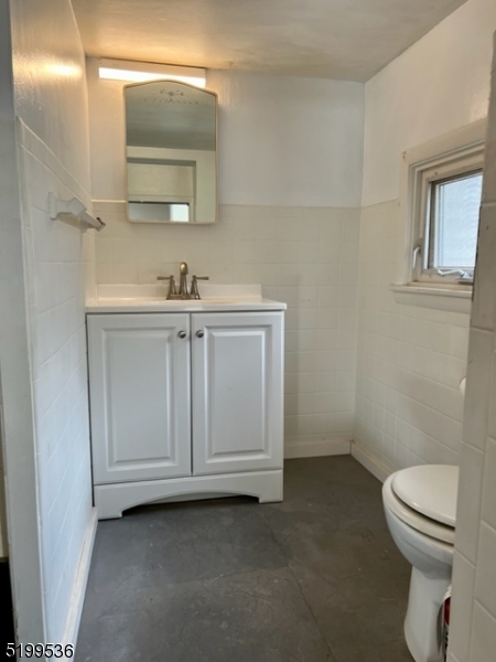 175 Green Pond Road, Unit C Rockaway, NJ 07866 - Photo 4 of 5 a bathroom with a sink a toilet and mirror