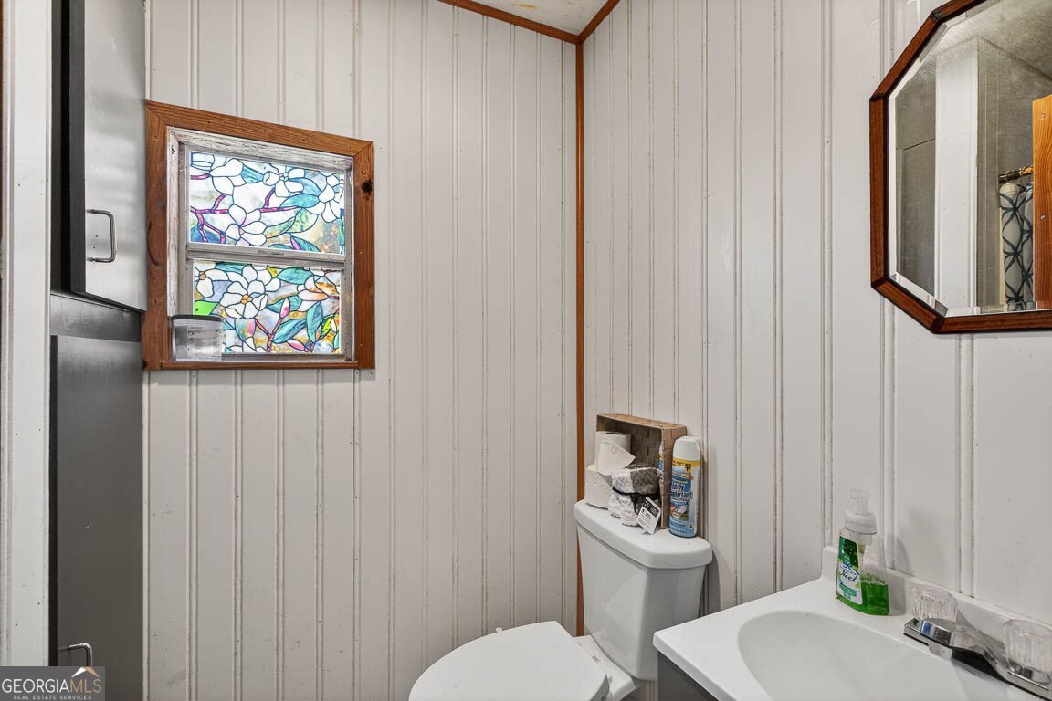 33 Warren Avenue Waverly, GA 31565 - Photo 29 of 63 a bathroom with a toilet a sink and a mirror